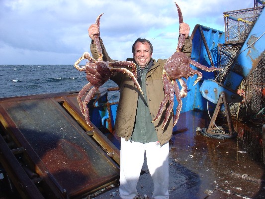 Company president Lance Nylander holding two freshly-caught king crabs.